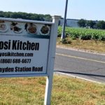 Yosi Kosher Kitchen sign by the road in front of the fields in Windsor, CT